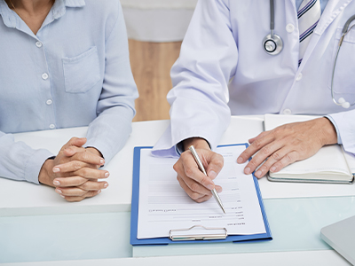Doctor checking and filling first patient medical history