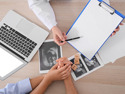 Couple consulting IVF doctor at fertility clinic top view